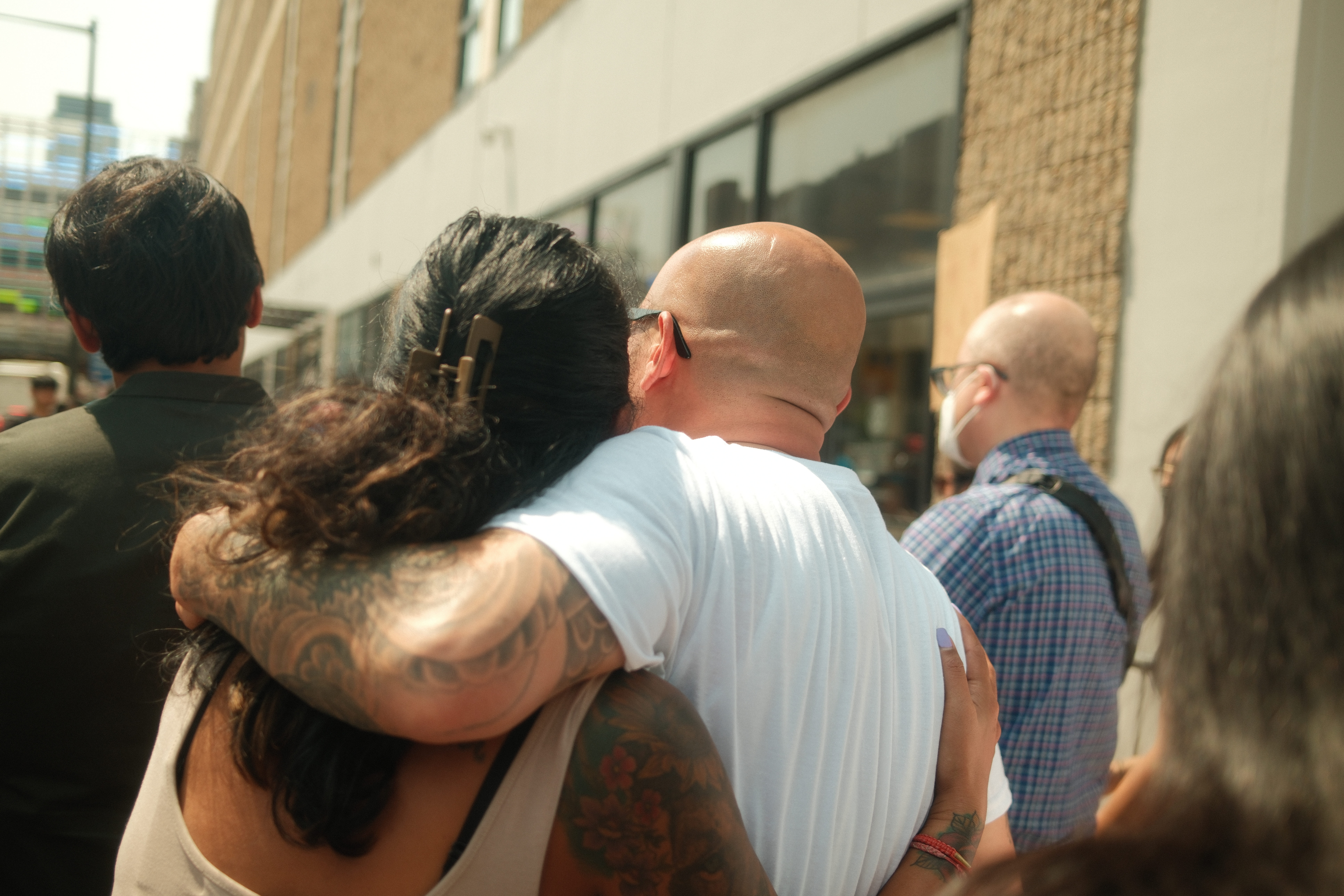 Sereyrath “One” Van hugs his friend during the rally before his check-in on August 15, 2024, outside of the Philadelphia ICE Field Office.