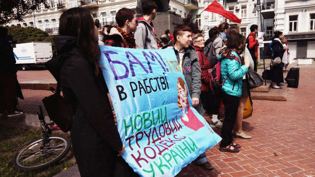 Sotsialnyi Rukh activists hold a poster decrying the implementation of the Amended Code of Labor Laws.