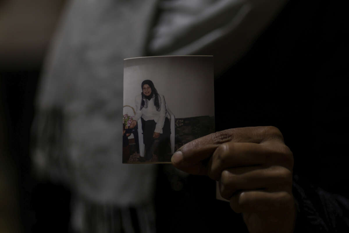 Nada Suleiman holds up a photo of her sister Mayada, who was forcibly disappeared by the Assad regime.